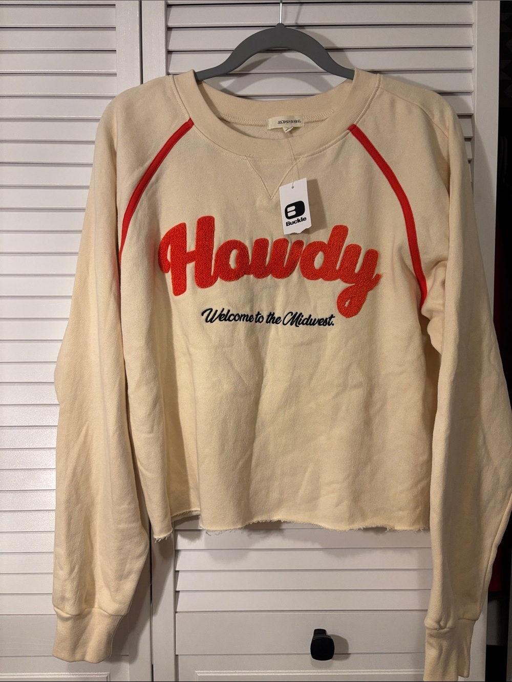 Buckle Cream Sweatshirt with Orange 'Howdy' Applique